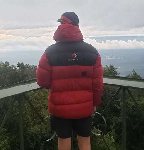 Alex in FA jacket on balcony on Mt Meru climb, Tanzania