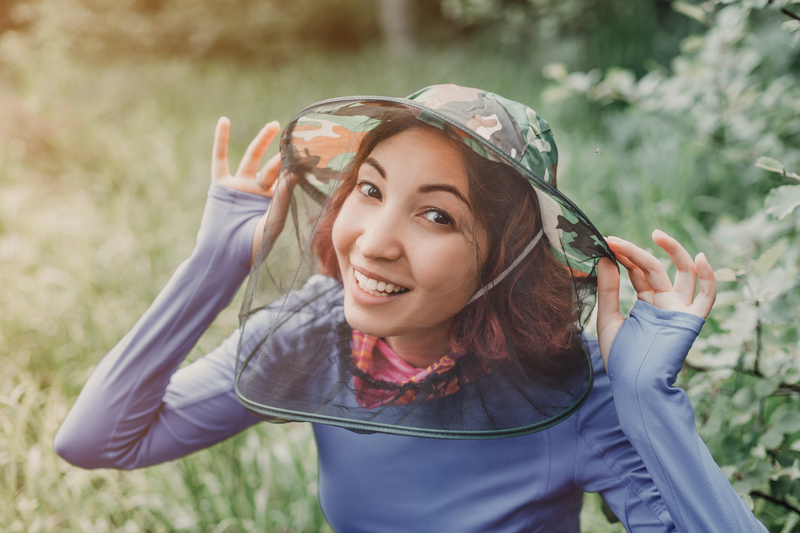 Woman wearing an anti-insect sunhat with a dropdown net