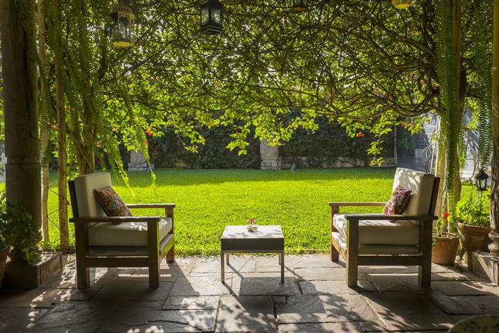 Two reclining chairs with garden behind at the Museo Larco cafe (image is theirs)