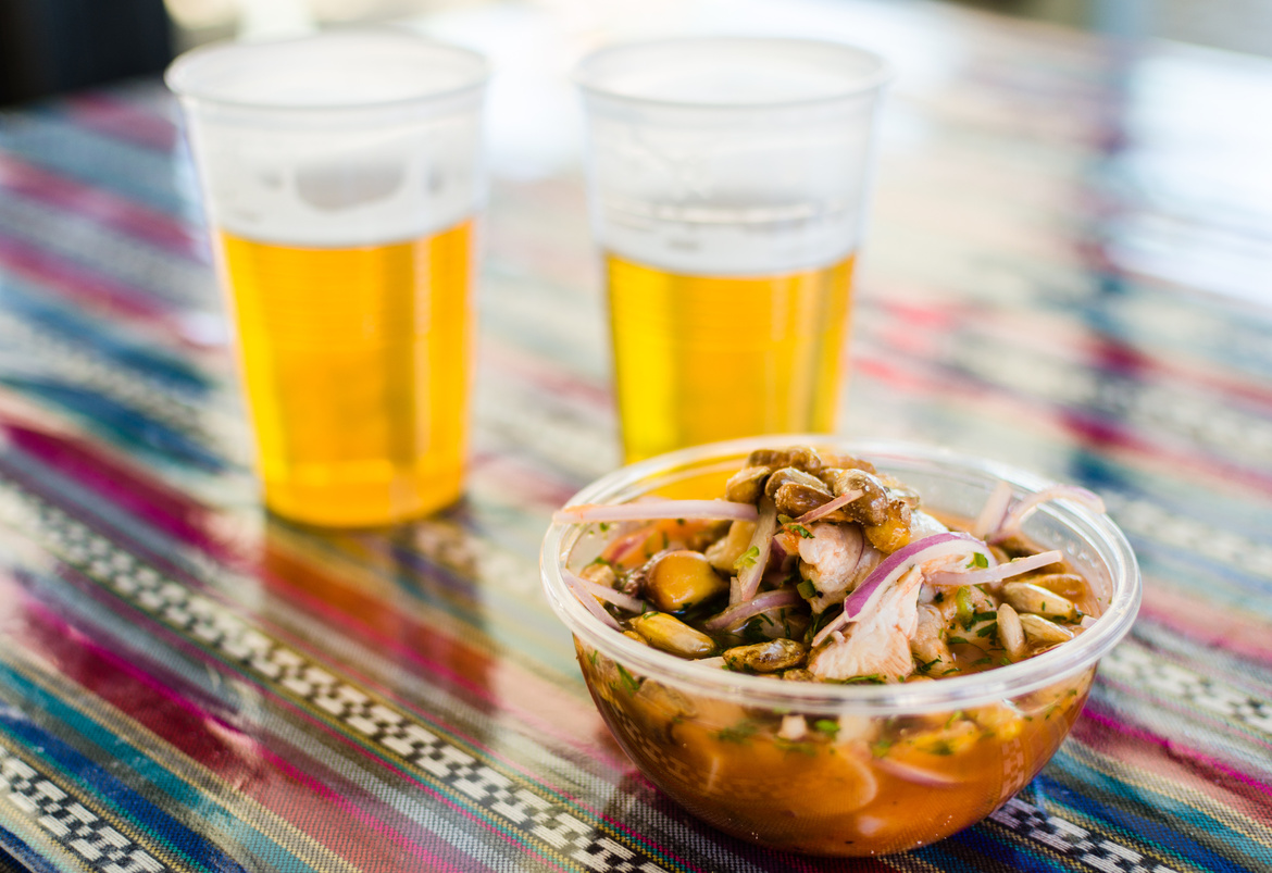 Ours. Ceviche and beer takeaway at a market in Peru 