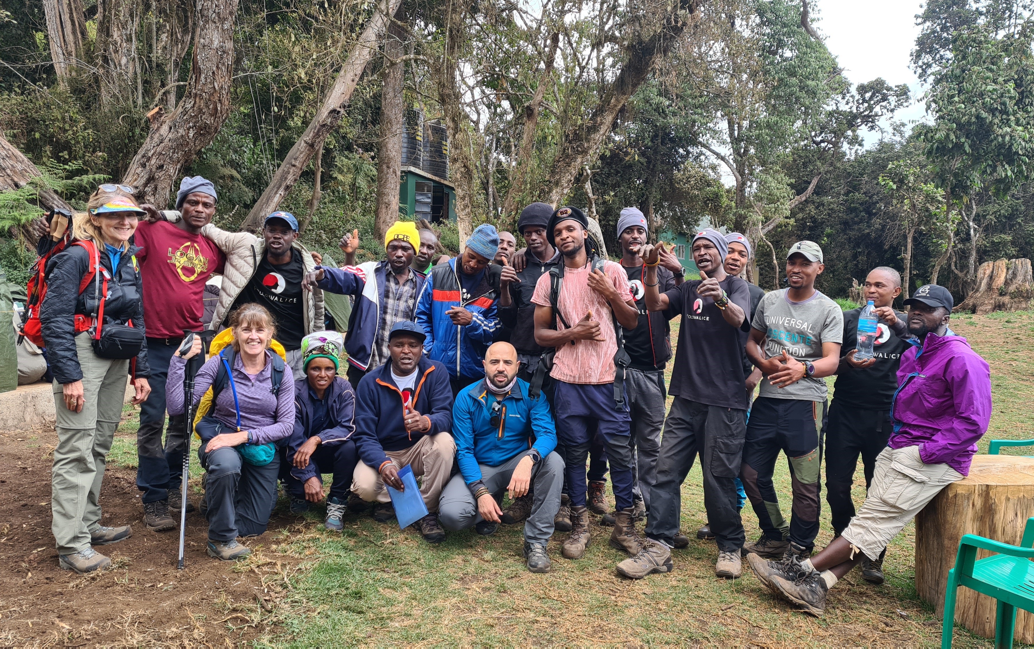 Group photo of trekkers and mountain crew at start of Kilimanjaro climb