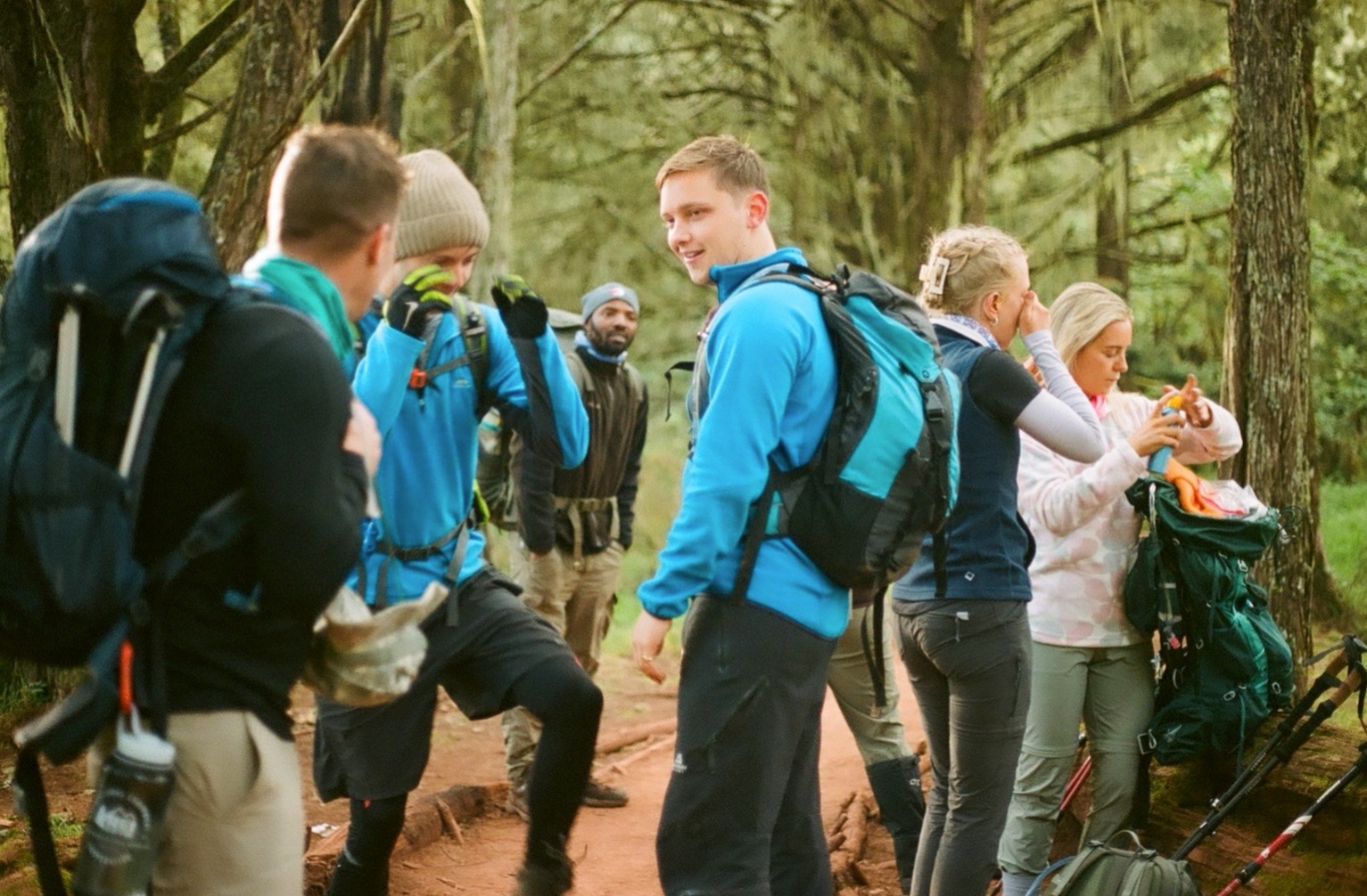 Jillian Tofukuji. Group of hikers in forest of Kilimanjaro