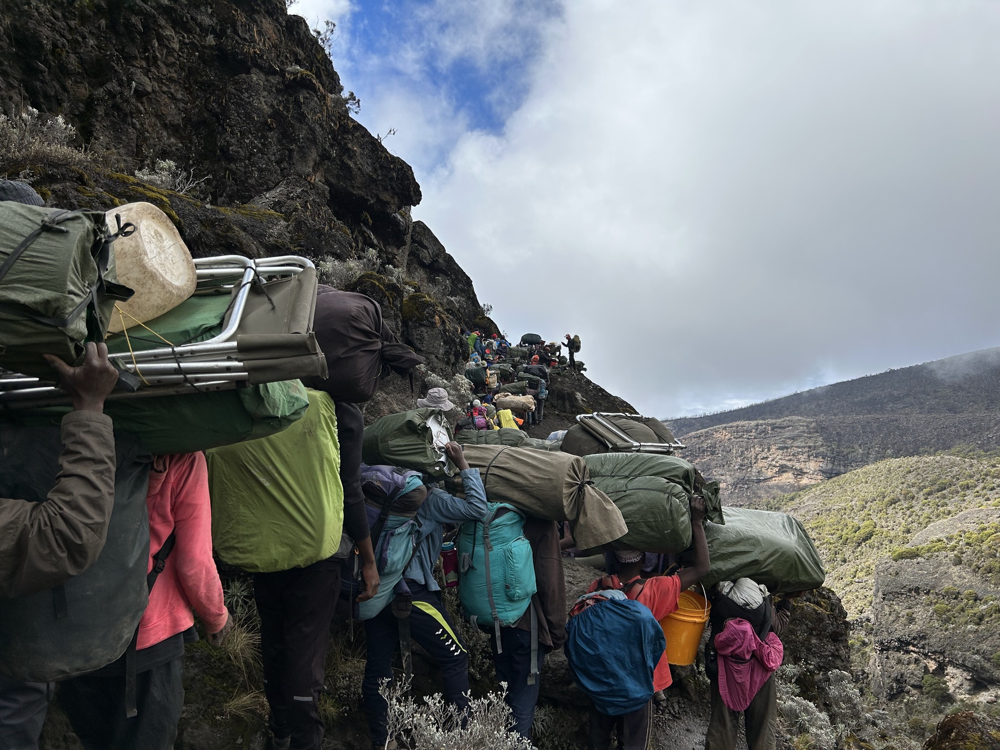 Romy. Porters and trekkers on Barranco Wall, Kilimanjaro