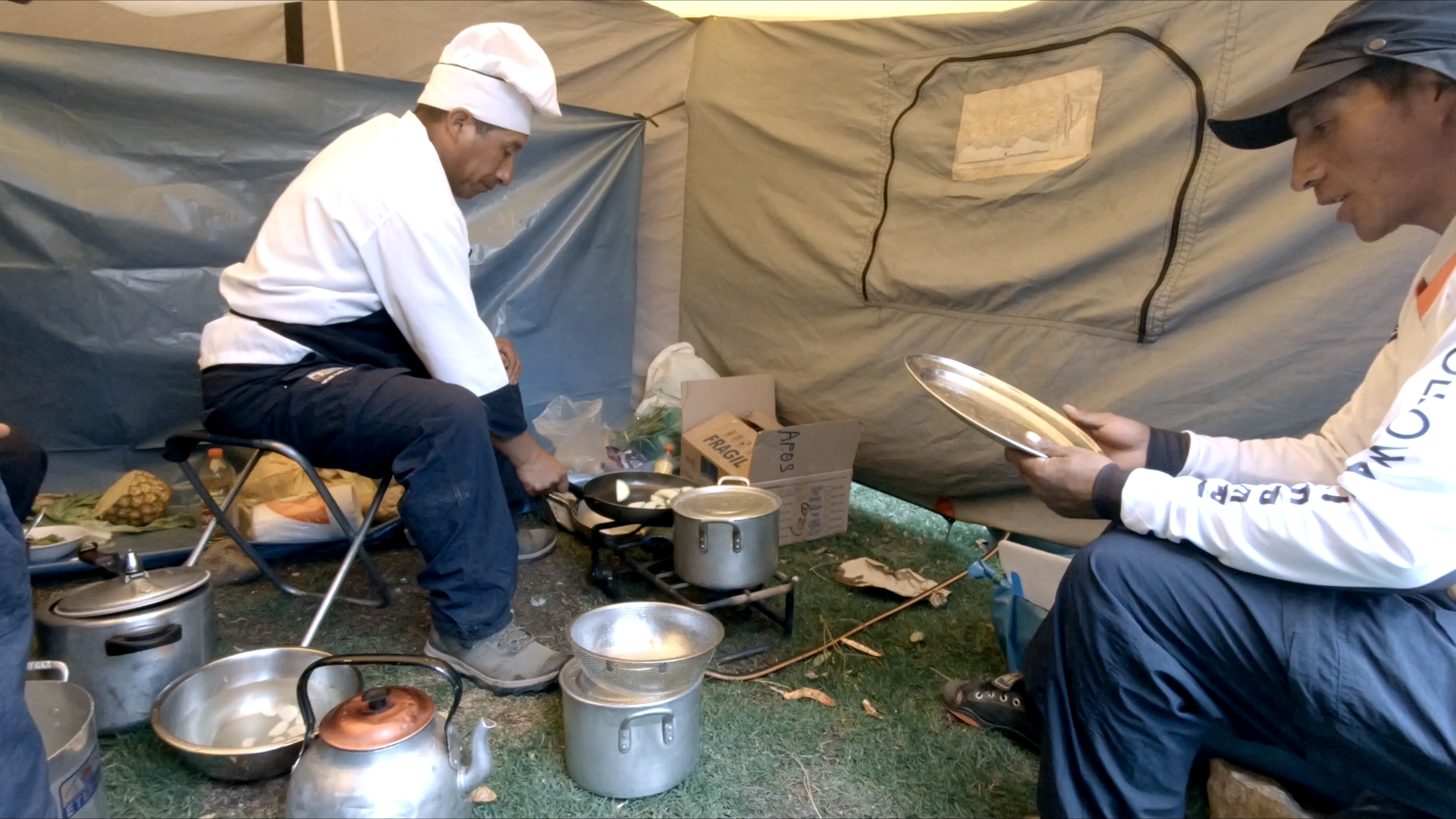 Follow Alice cook and assistant in tent on Inca Trail in Peru