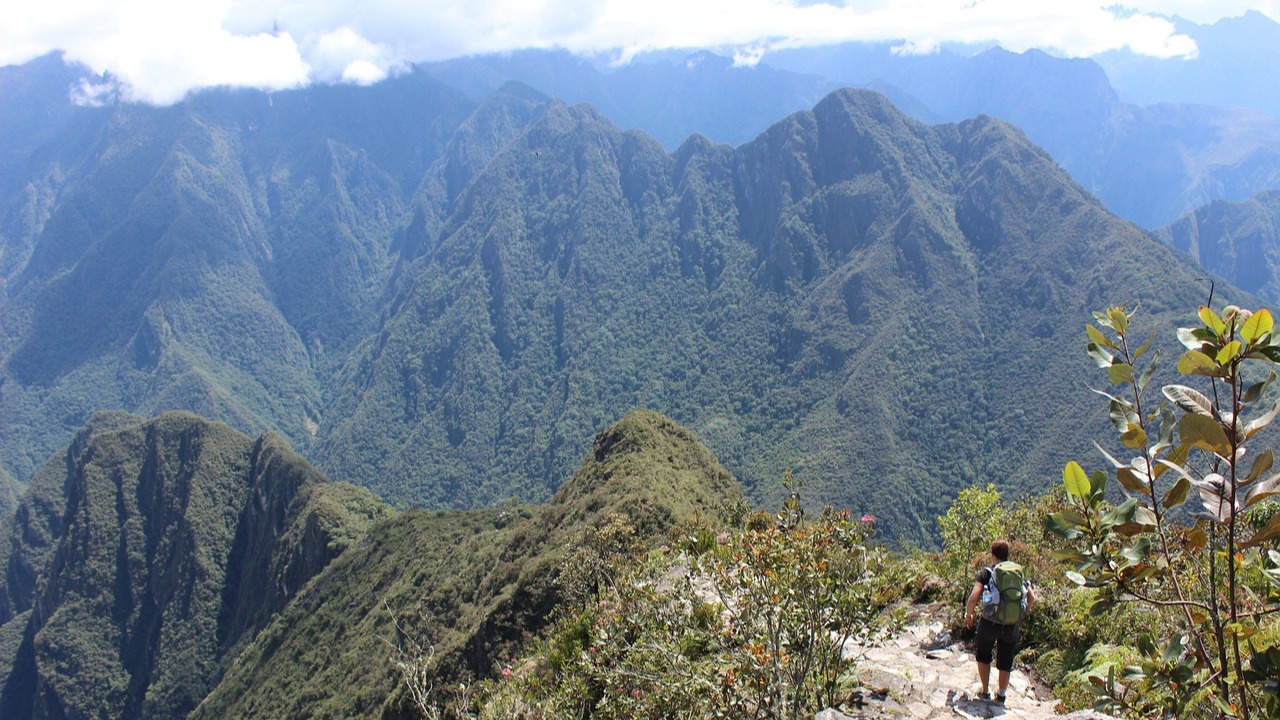 Man trekking in shorts and wearing a backpack on Inca Trail near Machu Picchu in Peru