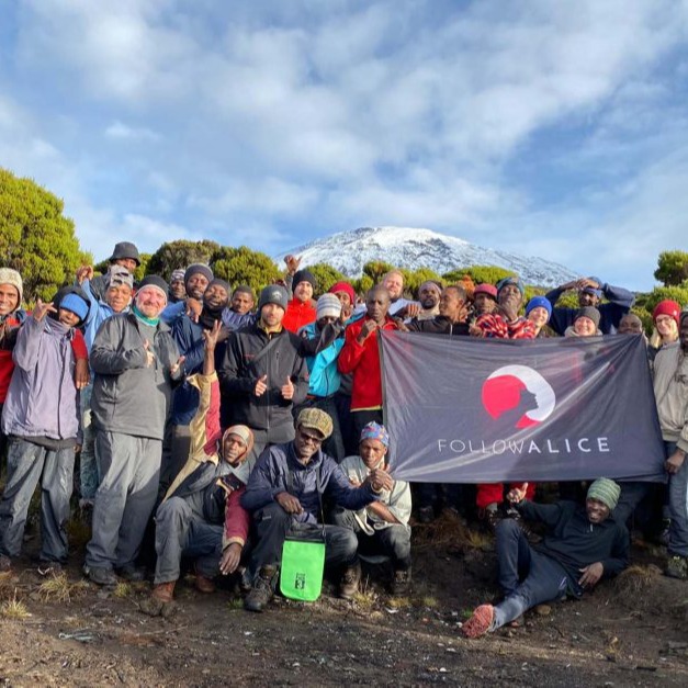 Dwayne's group Picture Kilimanjaro Team Holding Flag