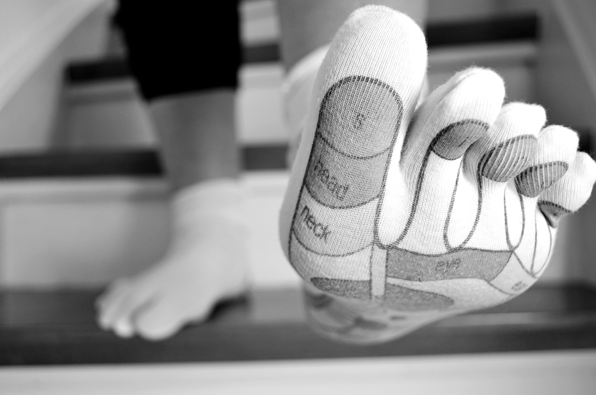 Close up of a foot in a toe sock on stairs