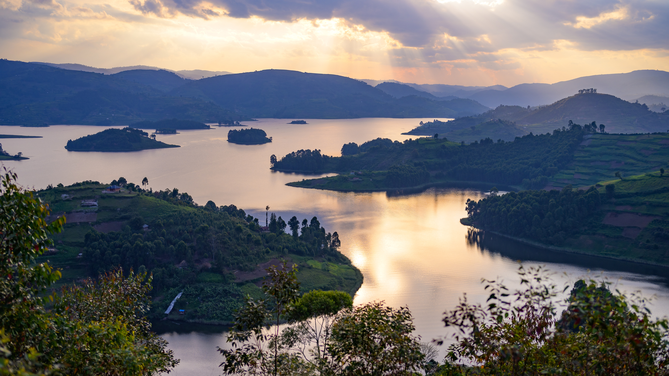 Beautiful colourful sunset at Lake Bunyonyi Uganda, cloudy sky, aerial view