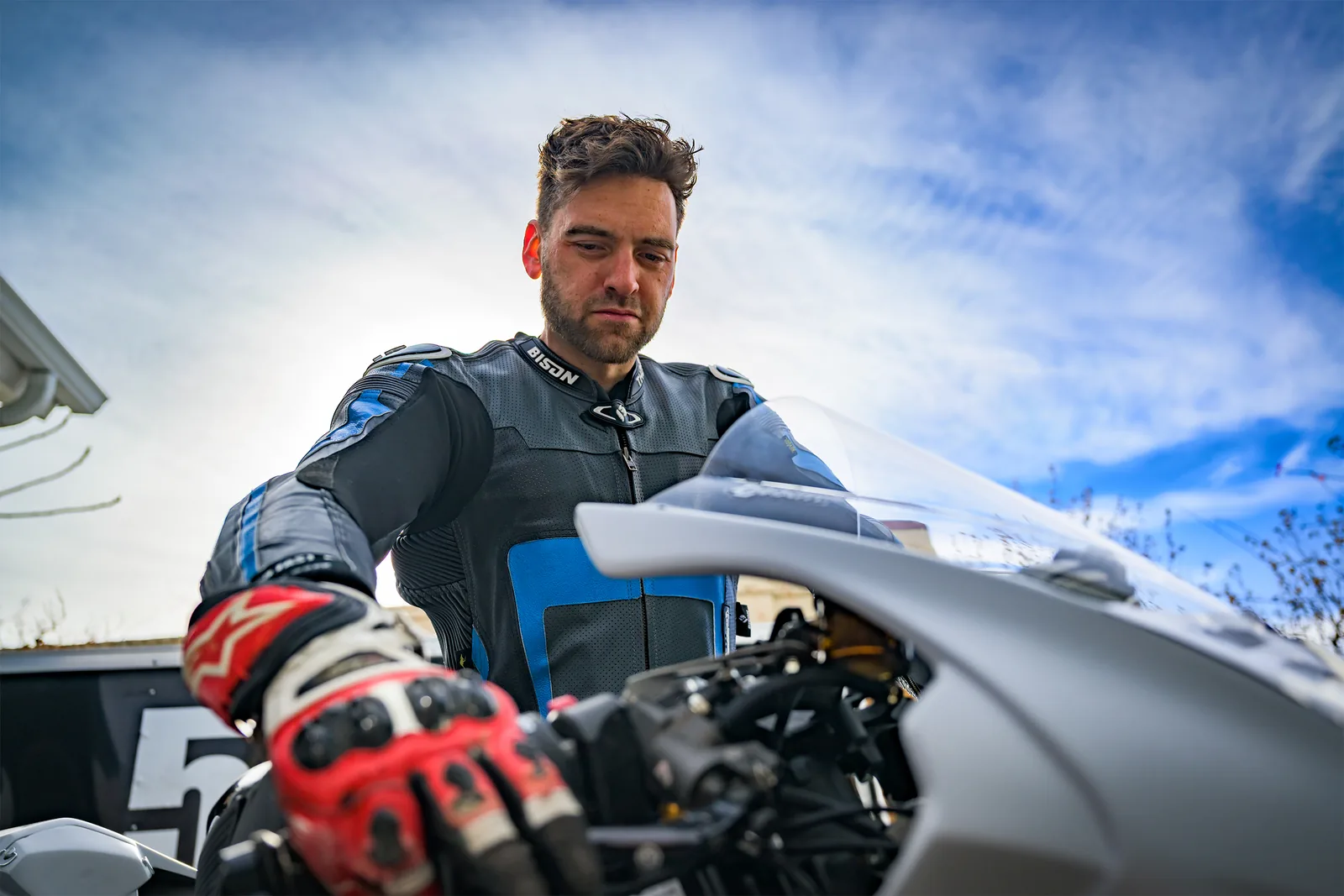 Dylan Unger in race leathers with bike #503 and MRA trophies