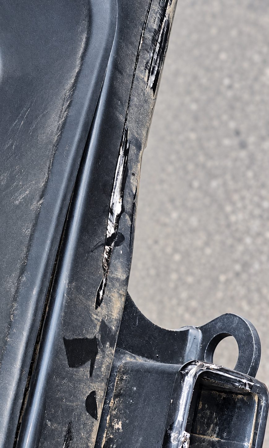 Scuffed rear bumper after a rear-end collision