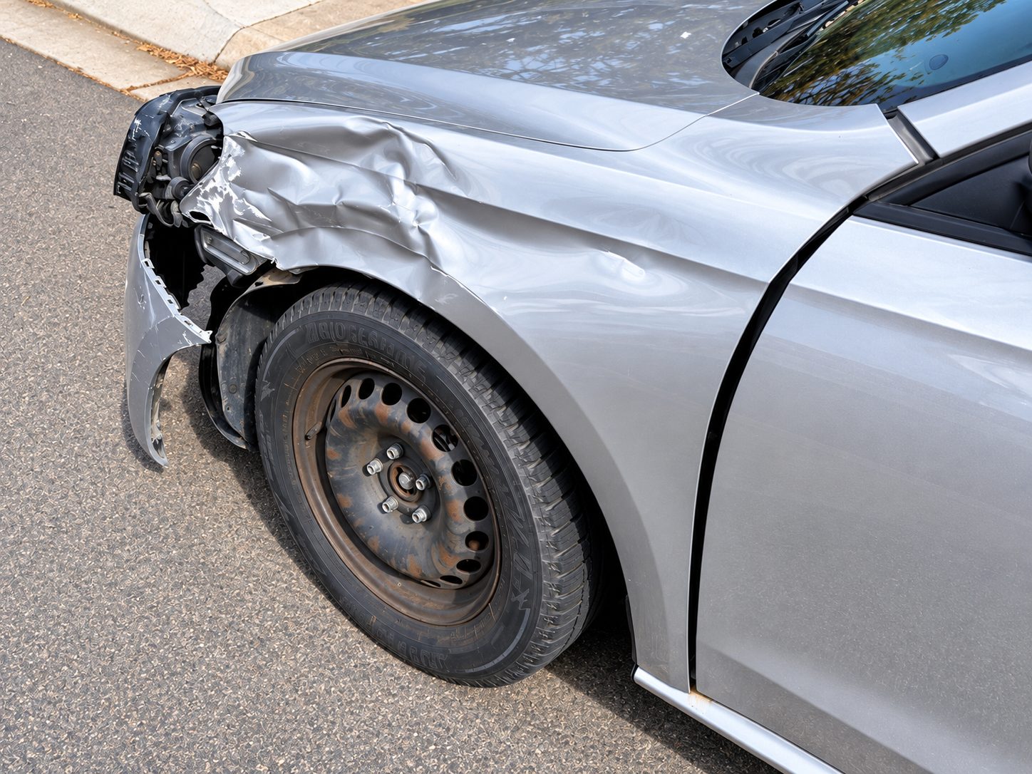 Front driver's side damage after a collision while leaving a parking spot