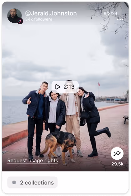 Four people standing on a waterfront promenade with a German Shepherd dog, a cloudy sky overhead.