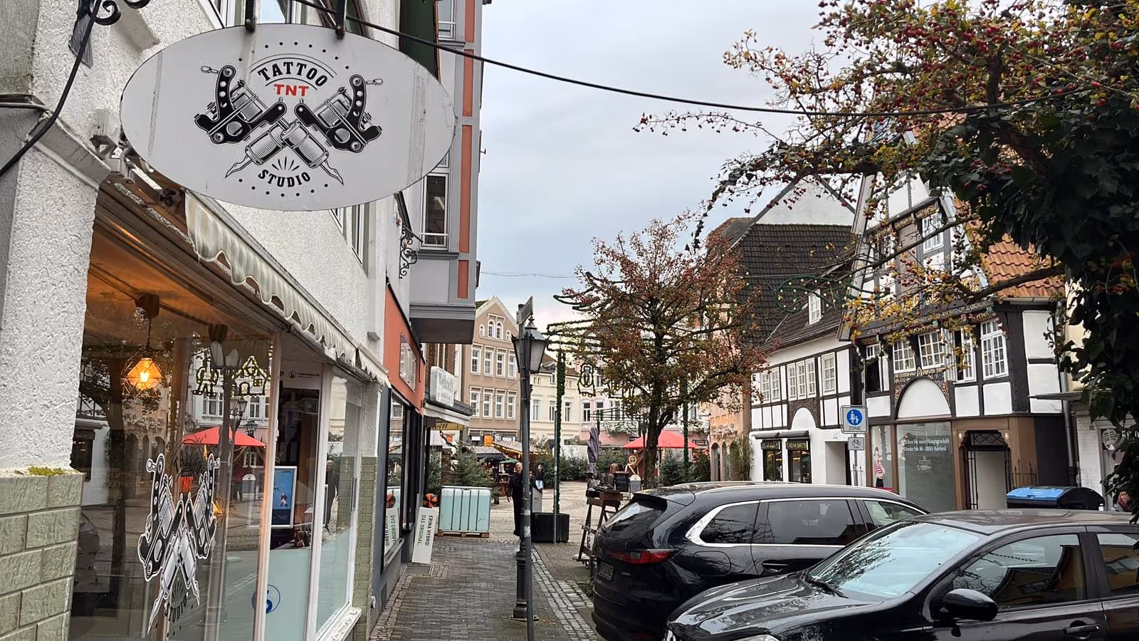 Außenansicht von Tnt-Tattoo in Herford mit Schild, Blick auf den Gänsemarkt vor dem Tattoo Studio.