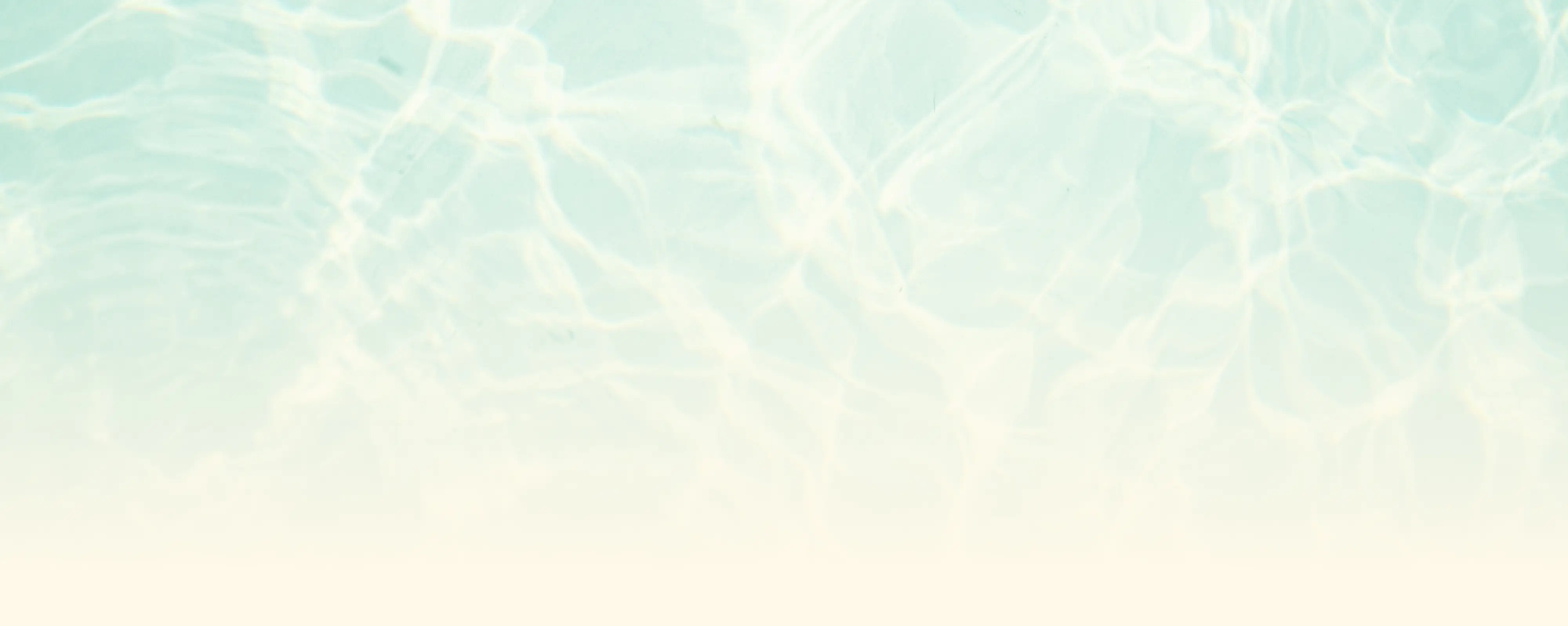 Light blue water surface with sunlight reflections and soft gradient fading to pale yellow at the bottom.