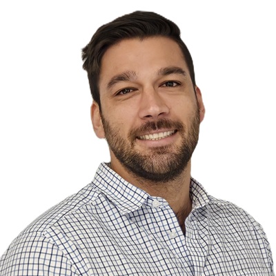Smiling man with short dark hair and beard wearing a white checkered shirt against a white background.