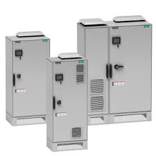 Three gray industrial electrical control panels of different sizes standing side by side.