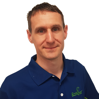 Man with short hair wearing a blue EcoXeet polo shirt smiling at the camera.