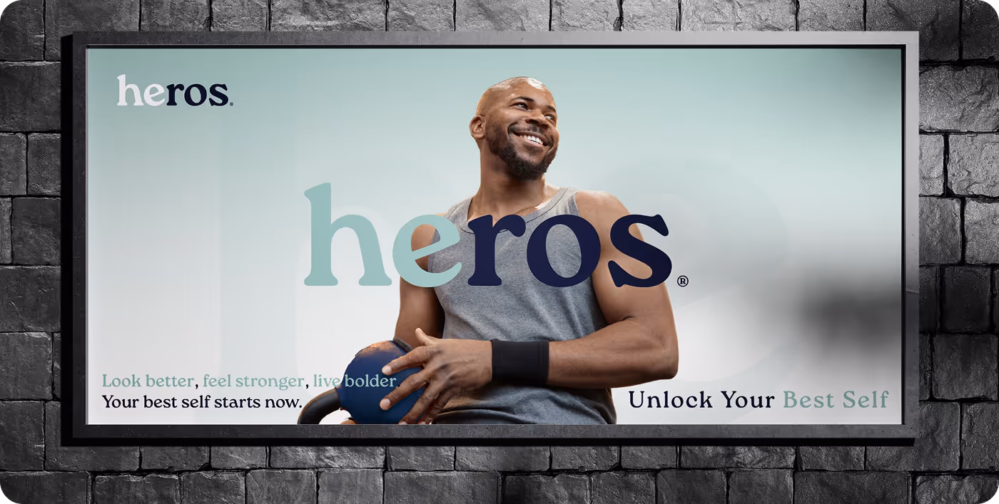 Smiling man in a gray tank top holding a blue kettlebell with heros brand text and phrases about unlocking your best self.