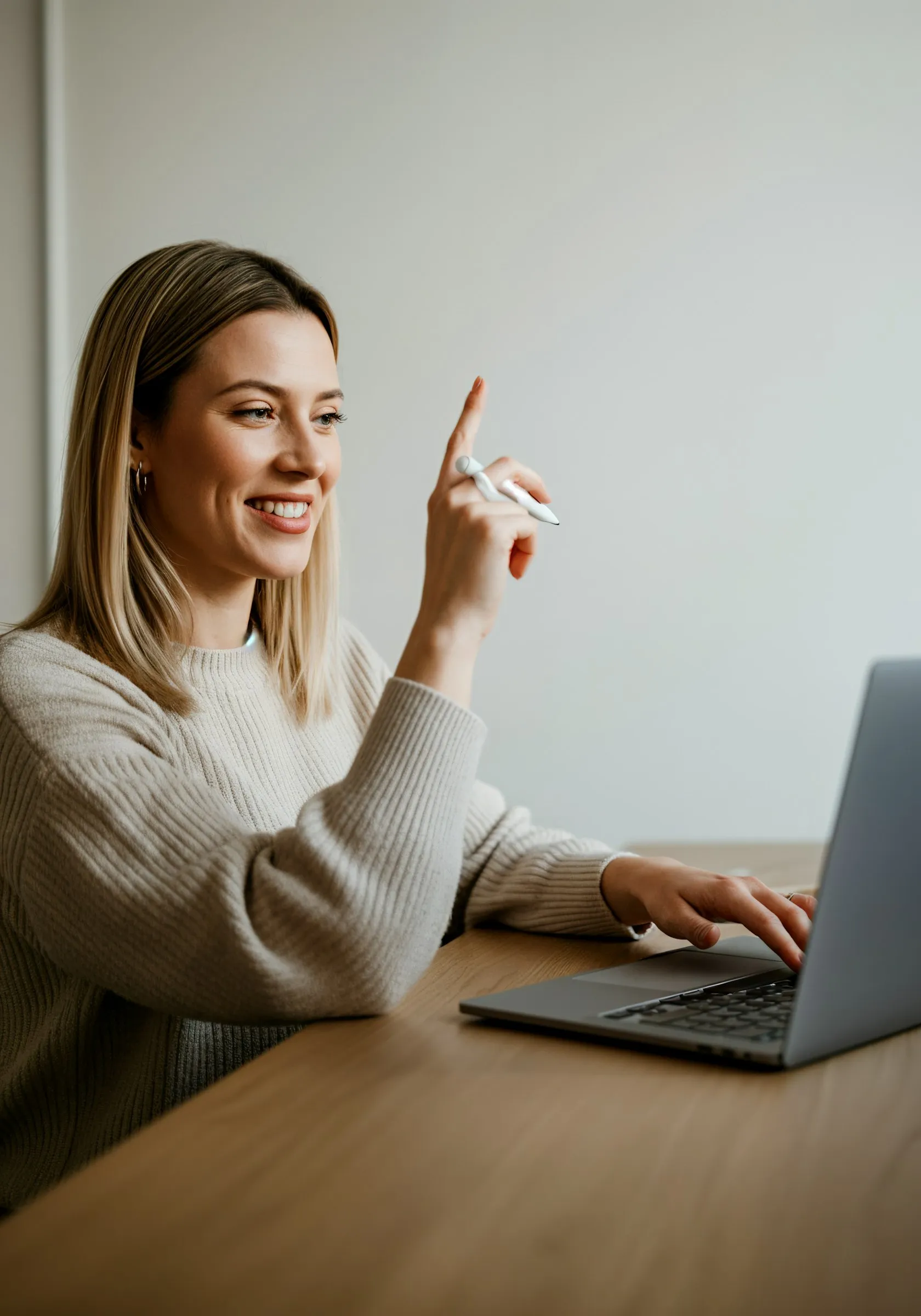 A woman sitting at a table with a laptop.