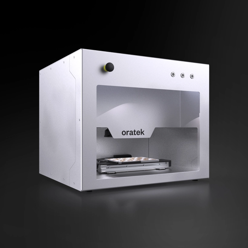 Oratek 3D printer with a white metal casing and a transparent front panel showing a printing platform inside.