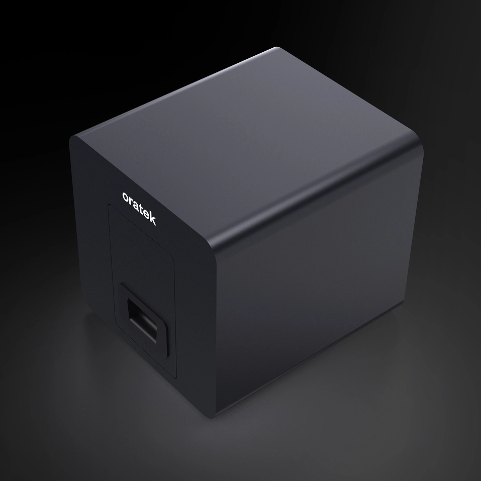 Black rectangular Oratek device with a rounded front edge and a handle-like feature on the front panel.
