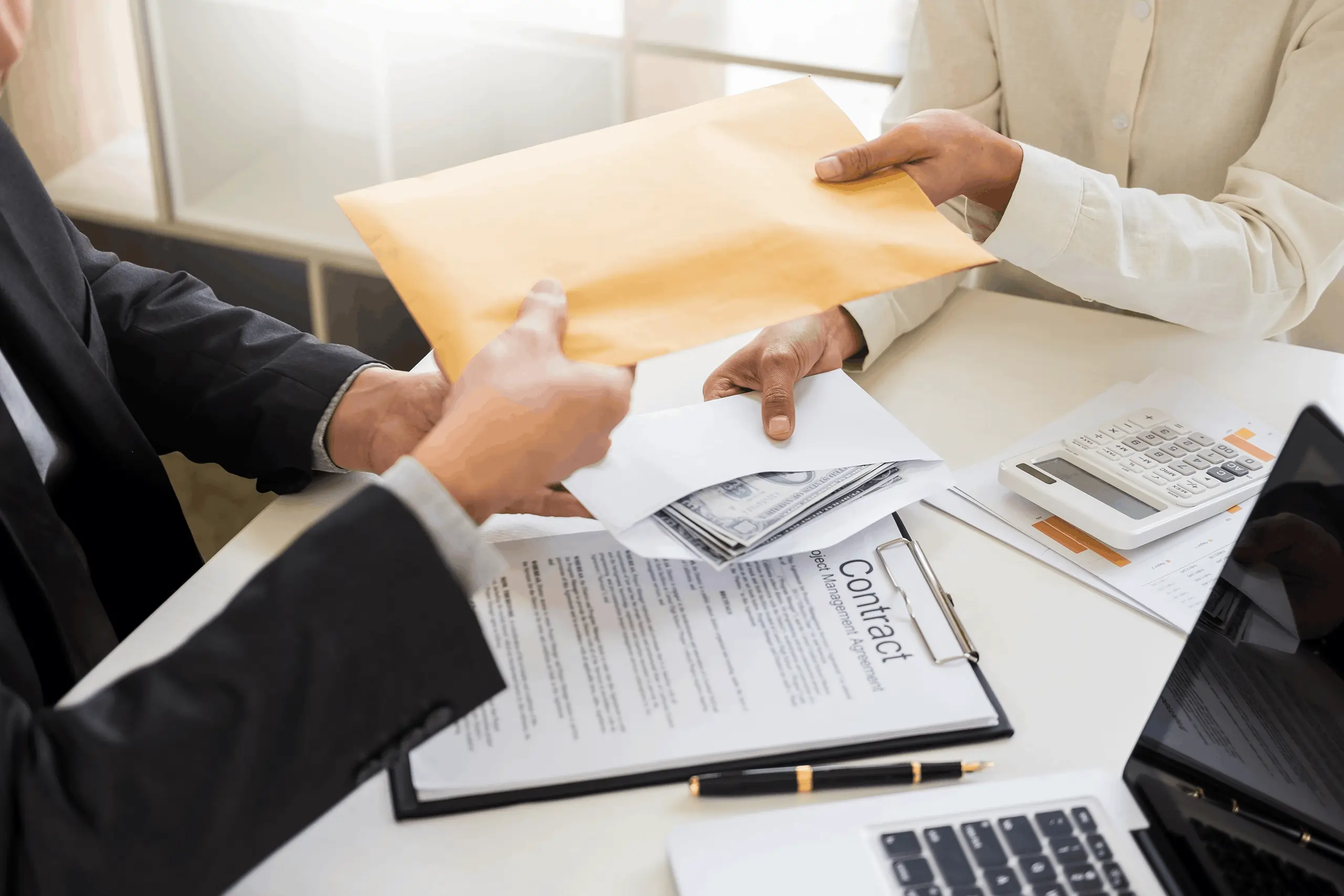 Businessman handing over a cash-filled envelope above contract documents during an EZ Capital funding agreement.