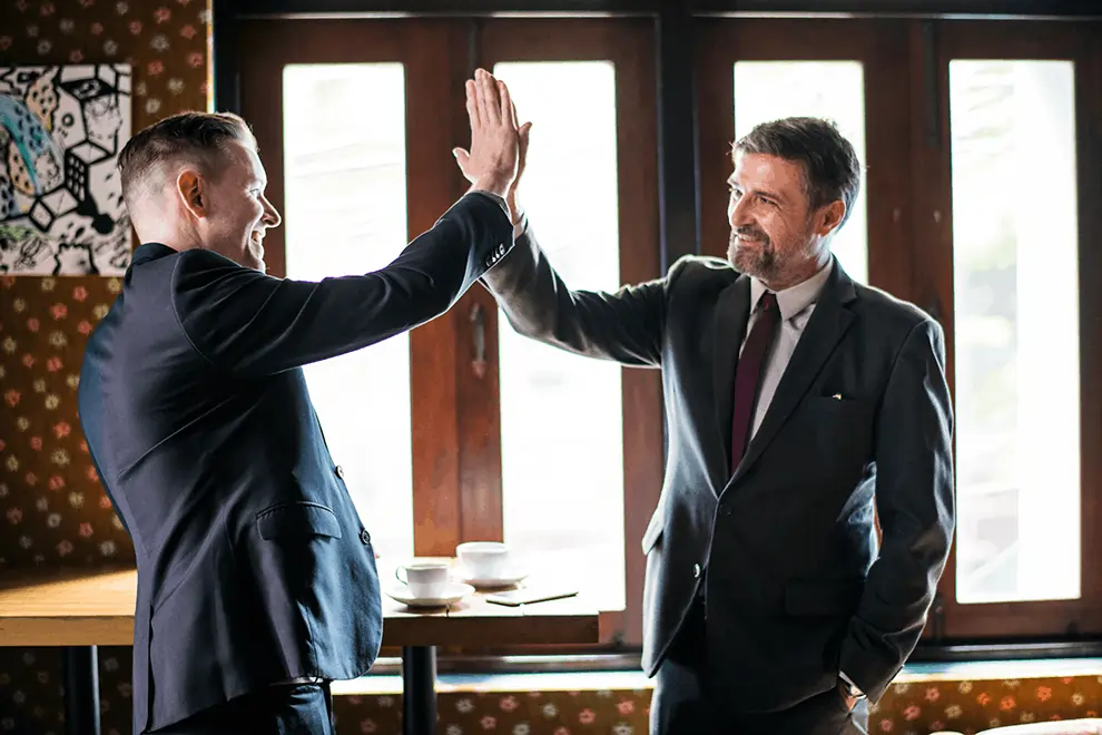 High five between business pros highlights success from US ezPay’s all-in-one reliable service and competitive pricing.