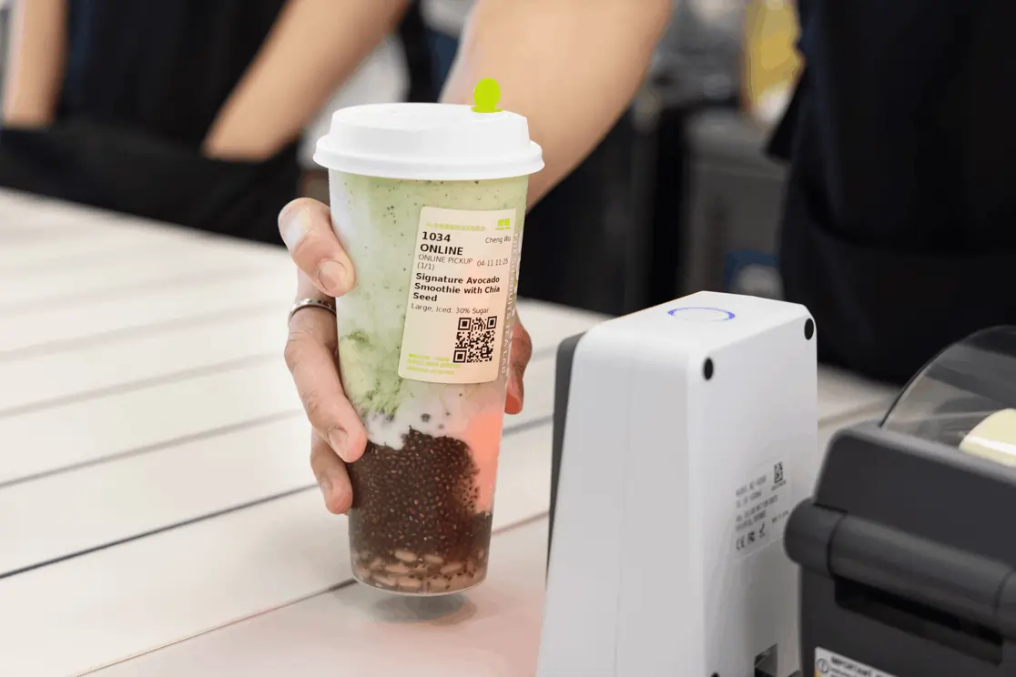 Signature avocado chia smoothie being scanned at register with scan to call technology during an online pickup at the counter.