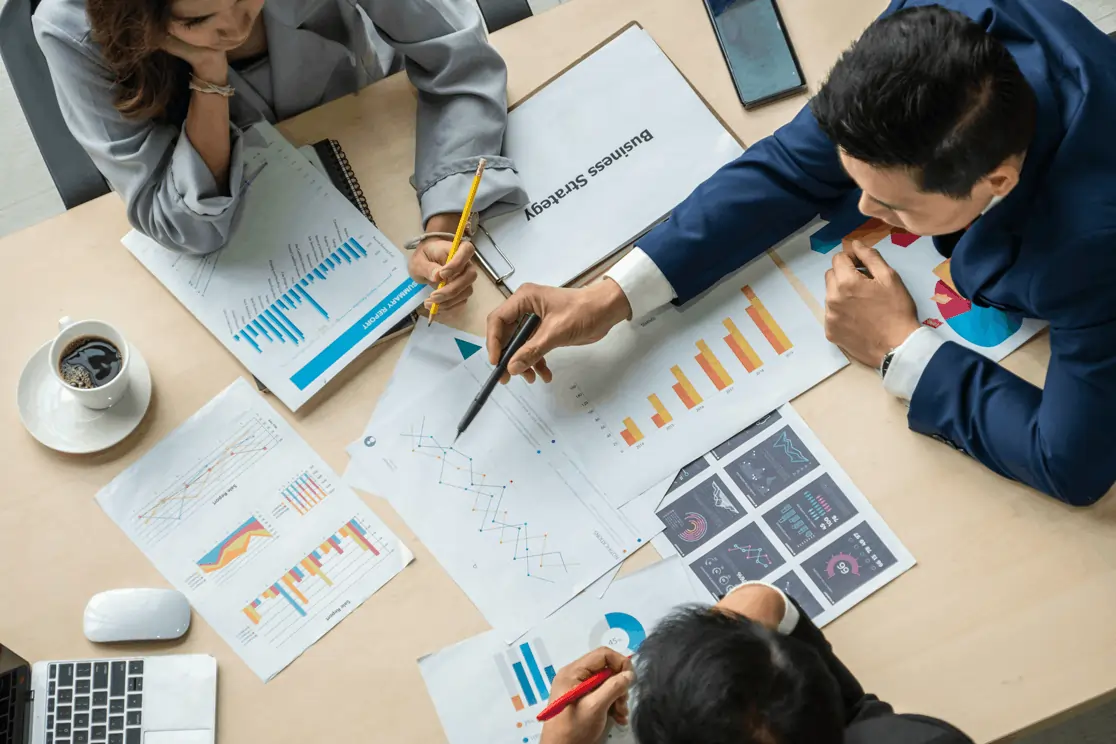 Team reviewing charts and graphs during a strategy meeting, using data insights to guide confident business decisions.