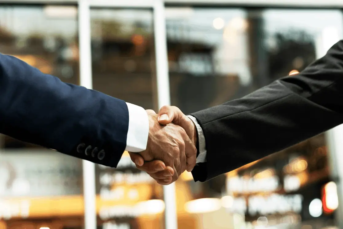 Close-up of a professional handshake symbolizing unified support for seamless business openings.