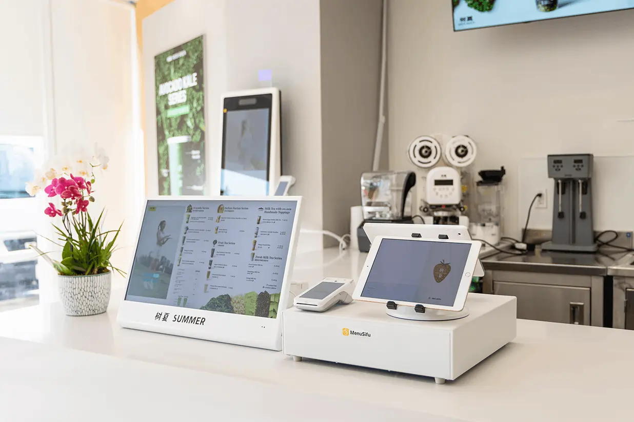 MenuSifu-powered POS setup in a bubble tea store featuring a tablet, digital display, and clean, modern workspace.