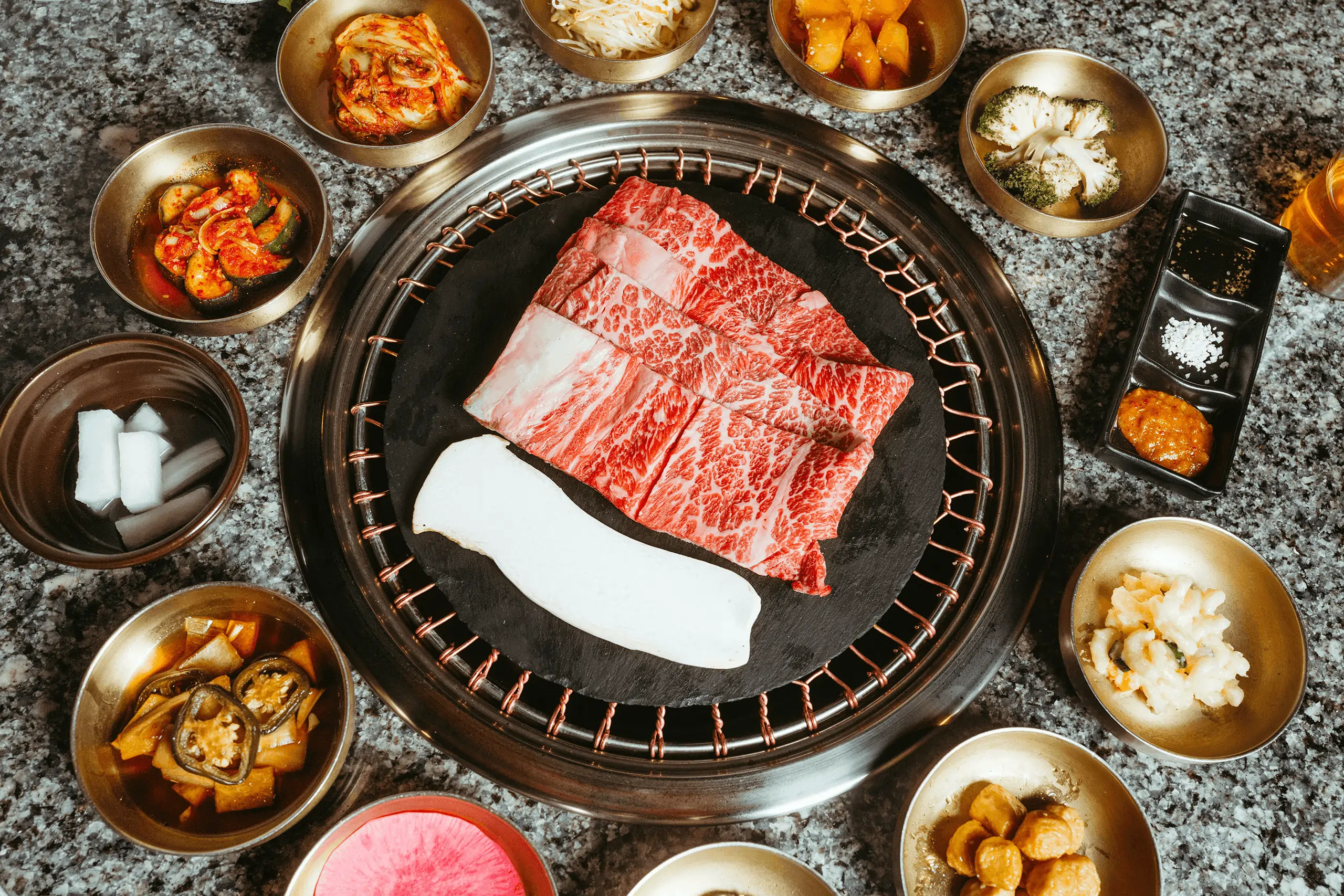 Korean BBQ setup with beef and side dishes, representing the authentic dining scene supported by a Korean restaurant POS system.