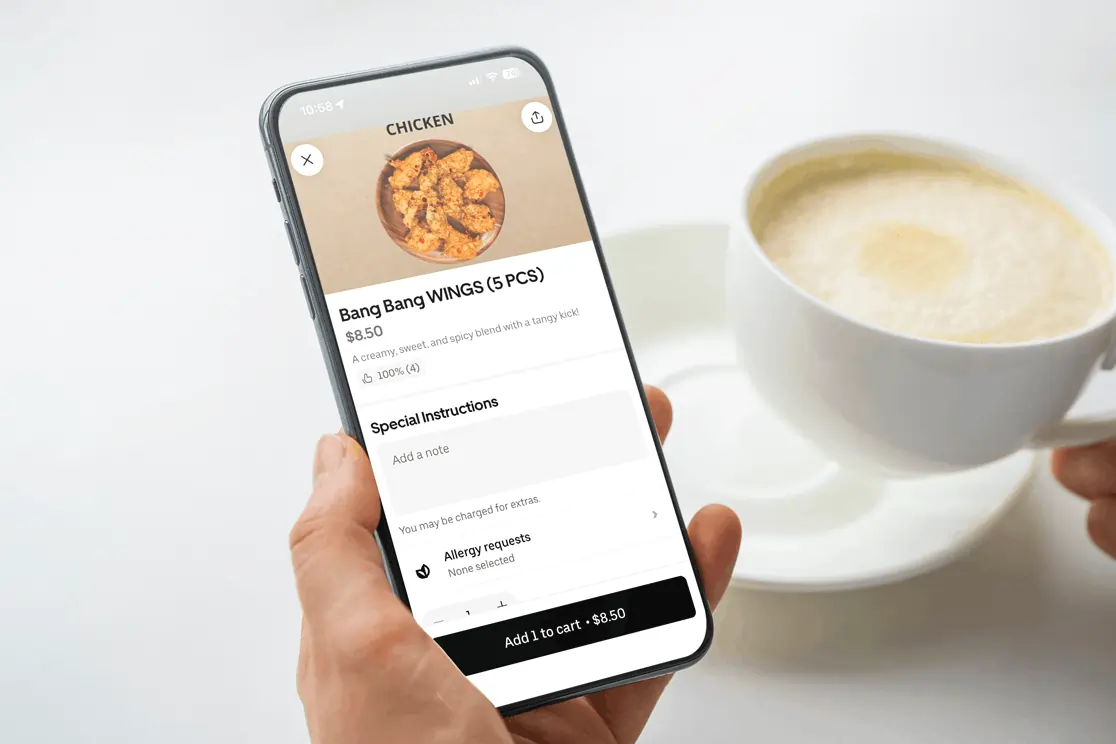 Customer orders Bang Bang Wings through a delivery app powered by a Korean POS system for seamless online ordering.