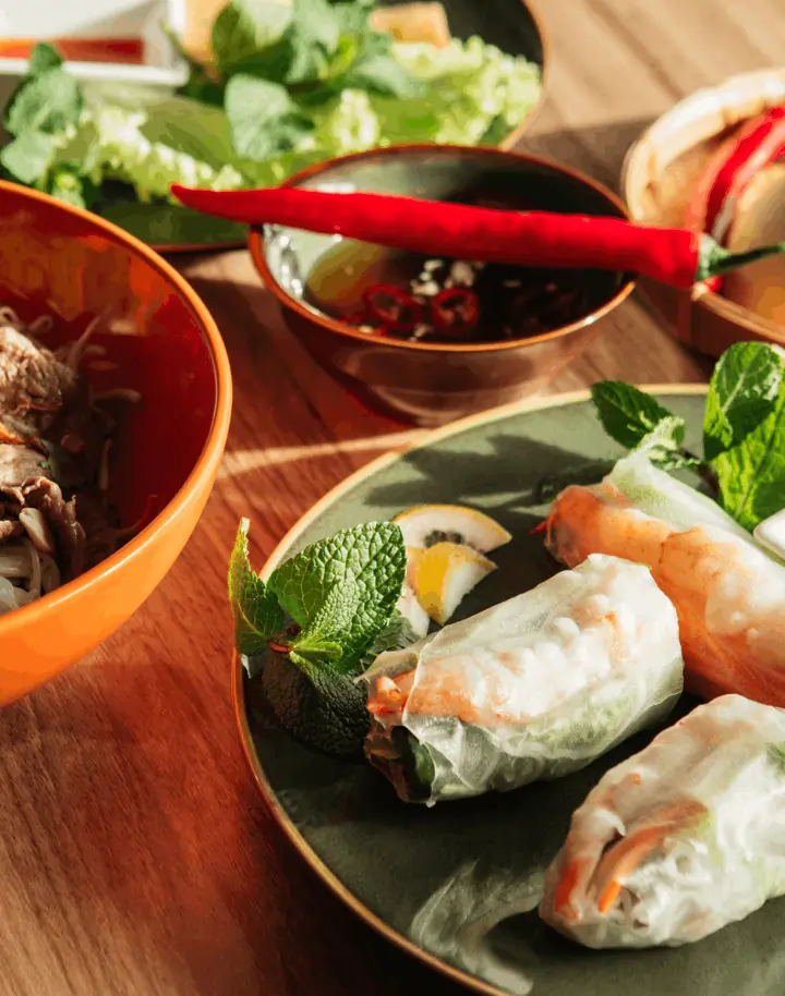 Freshly served Vietnamese pho and rolls ordered via Menusifu’s Thai restaurant POS system for smooth dining operations.