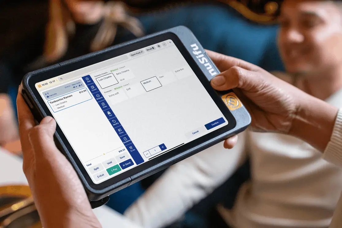 Server customizes a ramen order on Menusifu POS tablet at a Japanese restaurant.