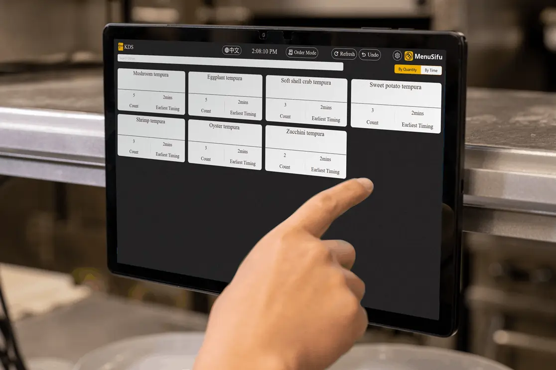 Kitchen staff using Menusifu KDS to manage tempura orders efficiently in a Japanese restaurant back-of-house environment.