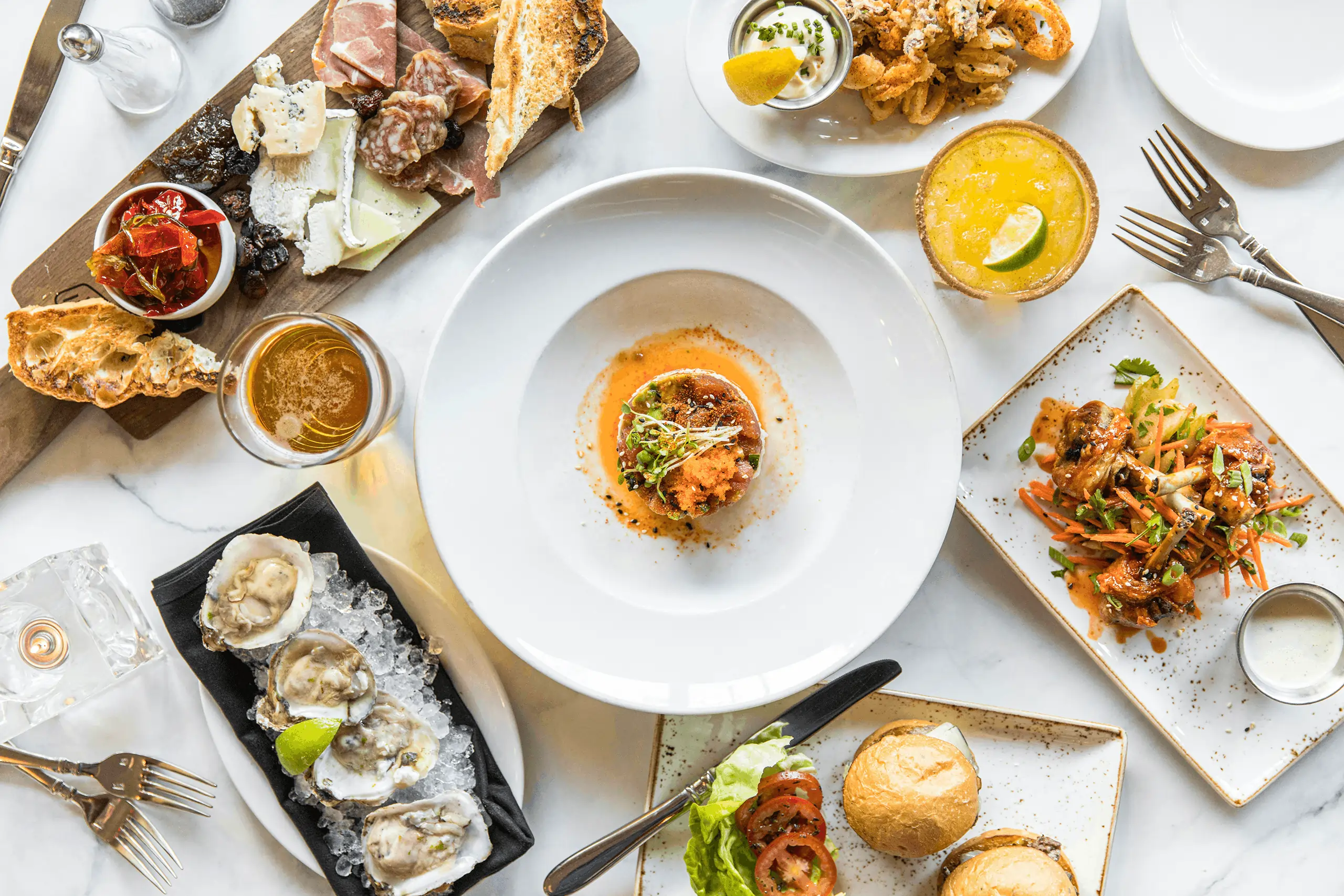 A table of gourmet dishes ordered using full service restaurant pos system.