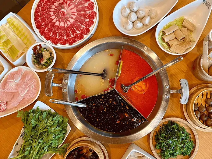Restaurant serves hot pot with broth variety, meats, and vegetables while promoting specials through SMS marketing.