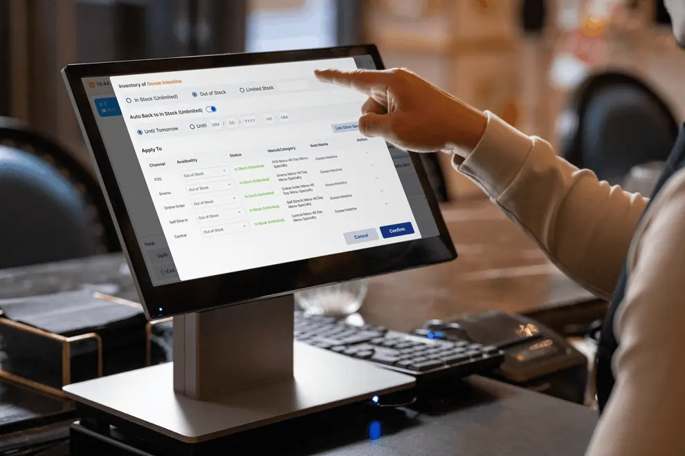 A user updates inventory across channels using a centralized menu control dashboard on a touchscreen.