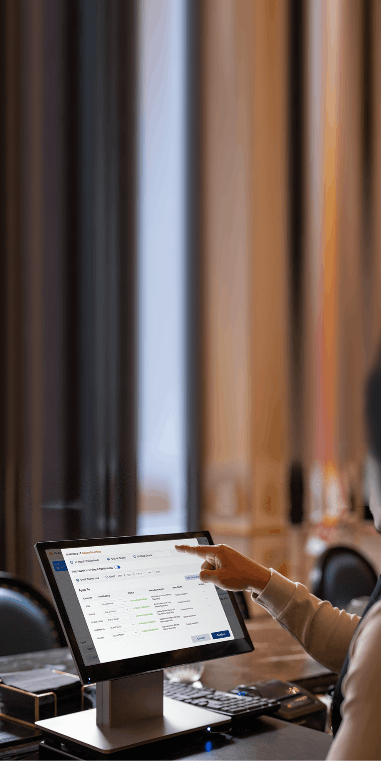 Staff using restaurant menu management software to set item stock levels and sync menus across ordering platforms.