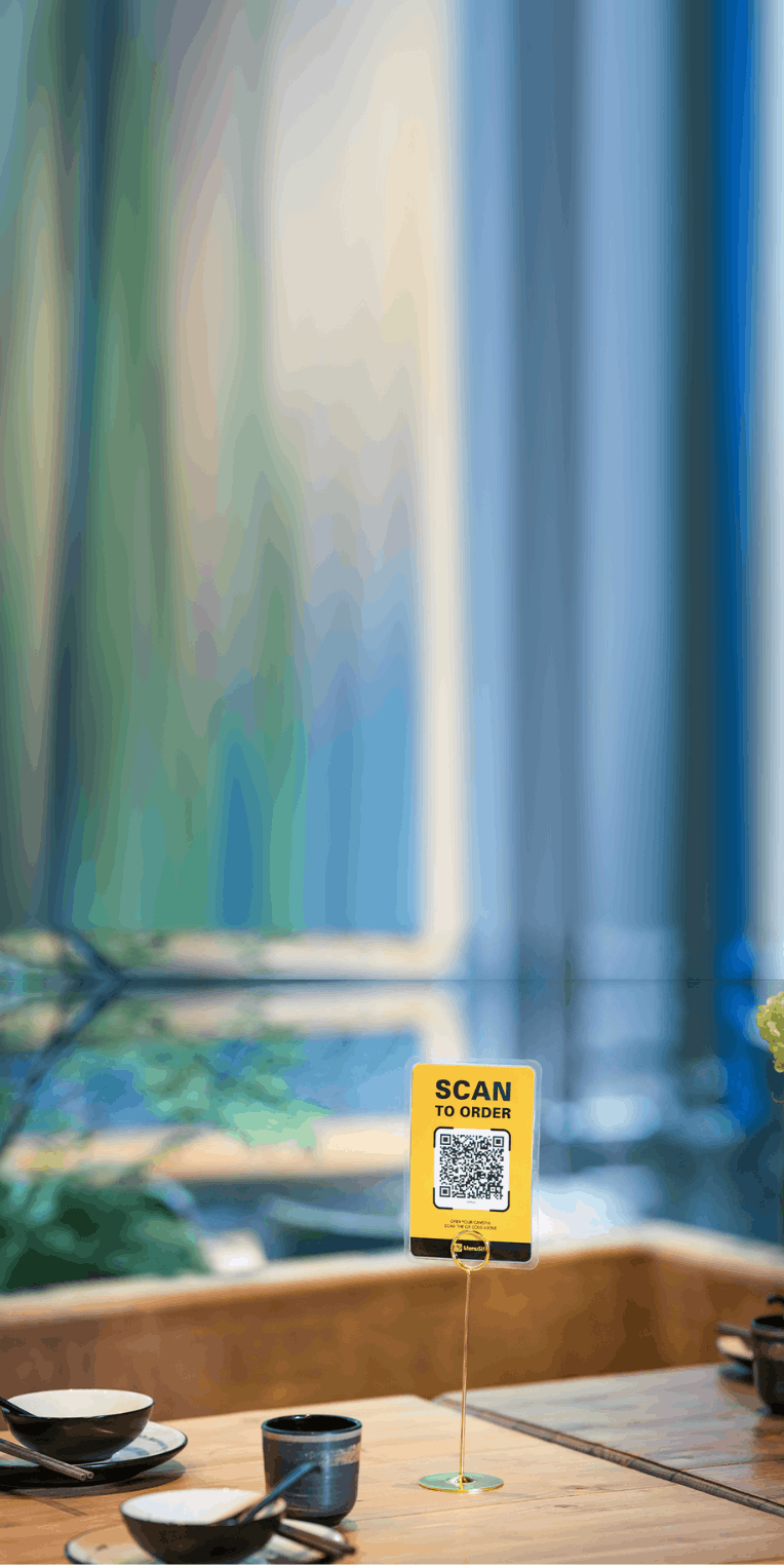 Scan to order restaurant setup with QR code display on a table for contactless menu access and ordering.