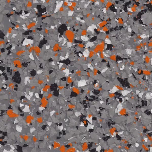 Textured surface with scattered epoxy flakes in ash grey, orange, black, and white colors.