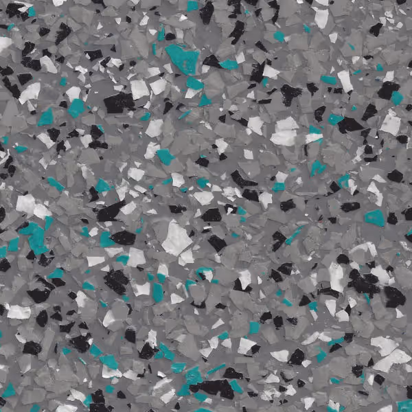 Close-up of epoxy floor coating with flakes in ashen gray, teal, black, and white colors.