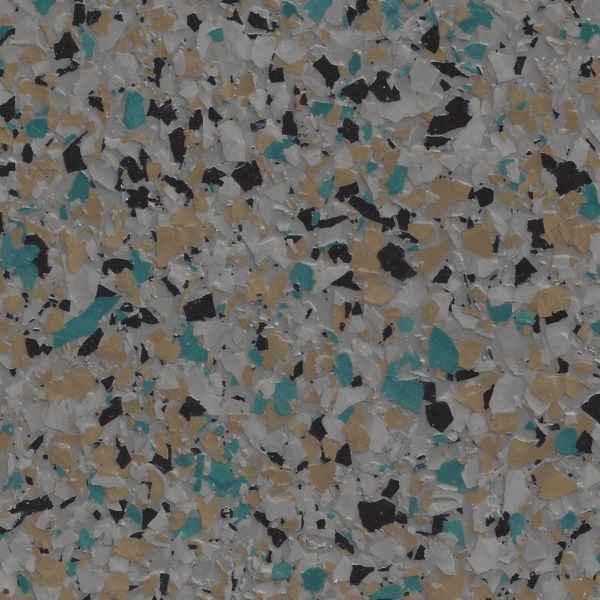 Close-up of a textured epoxy floor coating with scattered flakes in teal, tan, black, and gray colors.