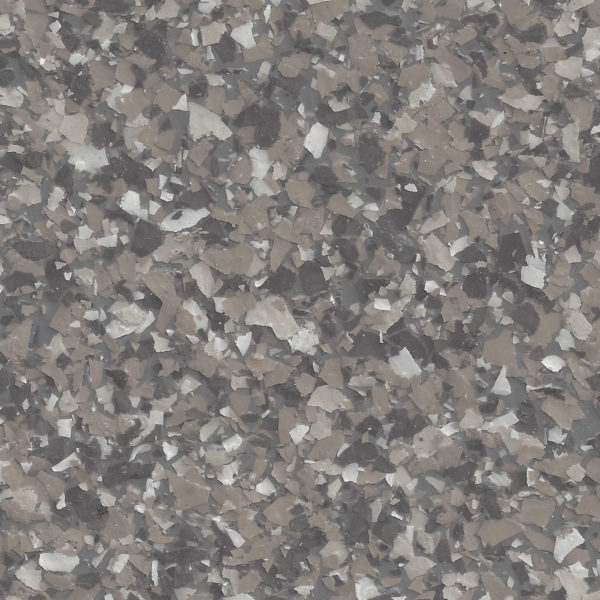 Close-up of a surface with gray, black, and white epoxy flakes creating a textured pattern.