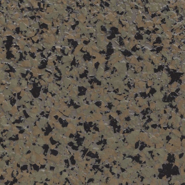 Close-up of epoxy flake flooring with scattered black, tan, and gray flakes on a brownish background.