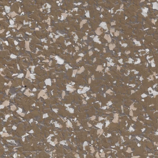 Close-up of brown epoxy flake flooring with scattered white and beige flakes.