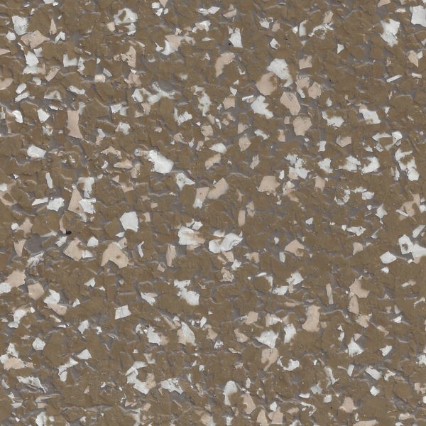 Close-up of brown epoxy flake flooring with scattered white and beige flakes.