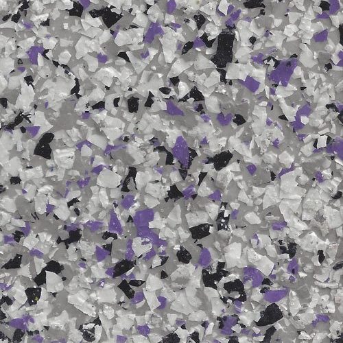 Close-up of a textured surface with white, black, and purple epoxy flakes scattered on a gray background.
