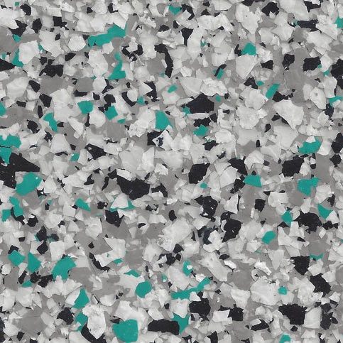 Close-up of epoxy floor coating with a flake pattern in white, teal, black, and gray colors.